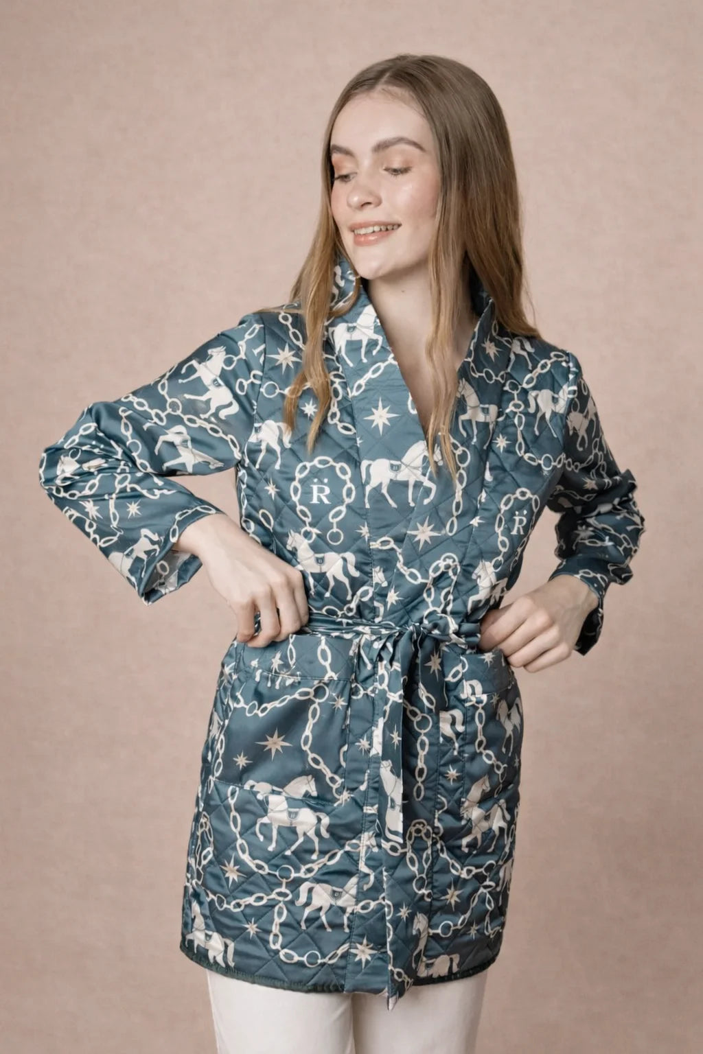 Woman wearing a blue patterned robe against a beige background