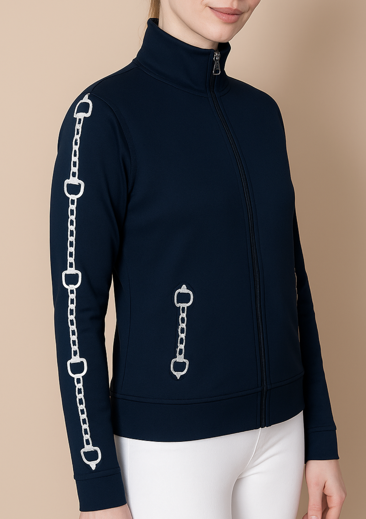Navy blue jacket with chain design on sleeves and back, worn by a person against a beige background