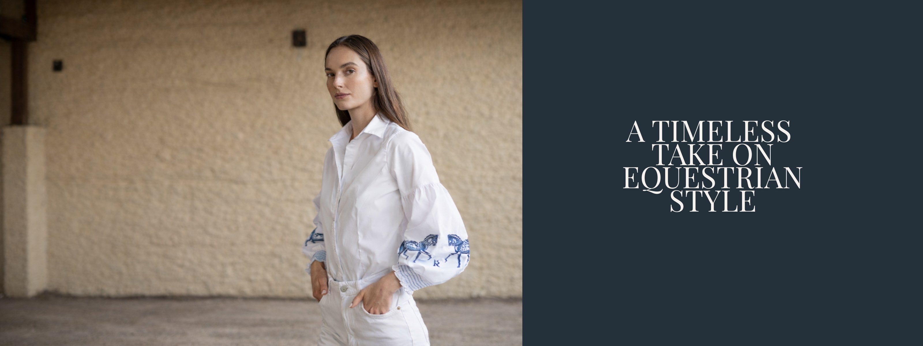 Woman in a white equestrian outfit with floral patterns standing in a stable.